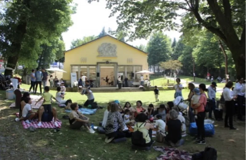 Famílias sentadas em mantas no parque, no Festival da Família